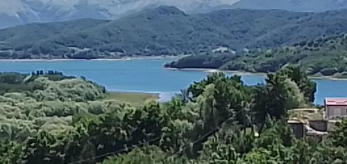 a view of a lake with mountains in the background at Hotel Aquila in Scoppito