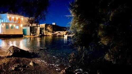a view of a body of water at night at Milos Boathouse-Between2seas Boutique in Areti