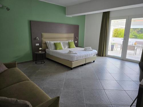 a bedroom with a bed and a couch at Domo Annalisa in Tortolì