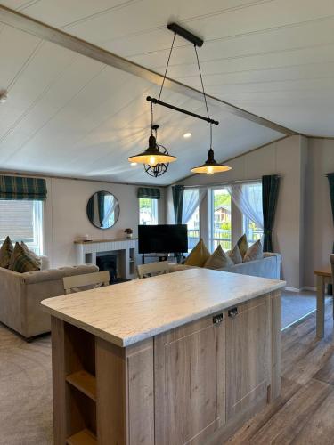 a kitchen with a large island in a living room at Sandy Lane 18 - Lodge with Hot Tub in Allerthorpe