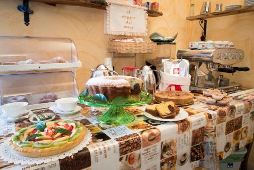 a table with a cake and other desserts on it at Il Poggio del Mare in San Mauro Cilento