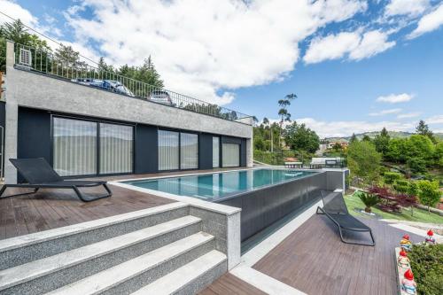 a house with a swimming pool and a patio at Casa do Horizonte in Vieira do Minho