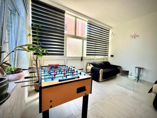 a living room with a foosball table in the middle at Santa Marinella Homes in Santa Marinella