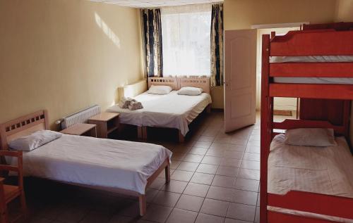 a room with two beds and a bunk bed at Arsenal in Daugavpils