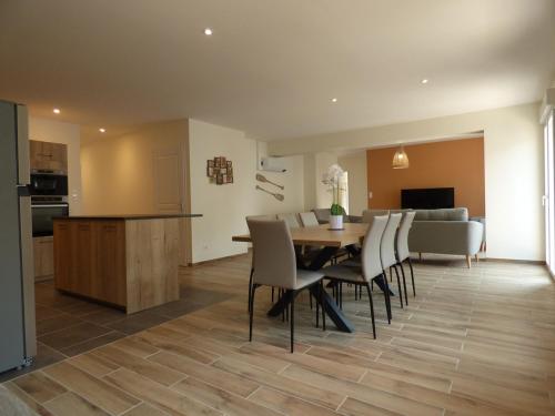 une salle à manger et une cuisine avec une table et des chaises dans l'établissement Le Jules Verne, appartement en plein centre-ville, au Crotoy