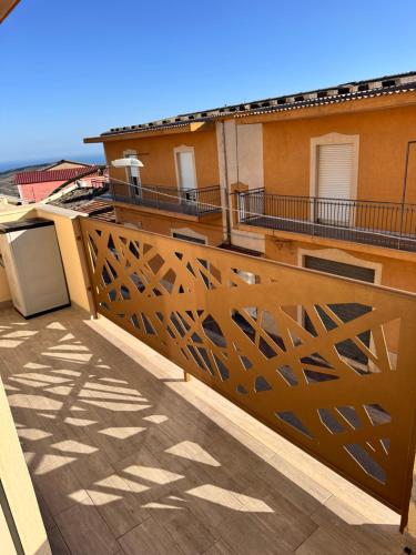 a balcony with a wooden railing on a building at HERMES Luxury Home in Agrigento