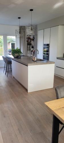 a kitchen with a large white island in a room at Casa del Breda in Breda