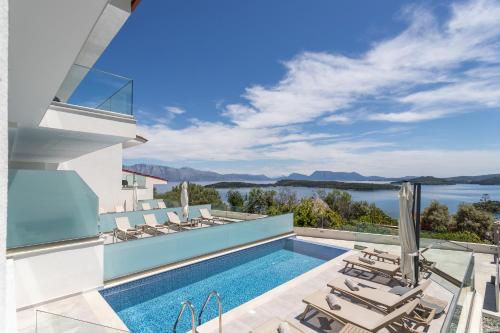 a villa with a swimming pool and views of the water at Diamond Blue Villas Lefkada in Nydri