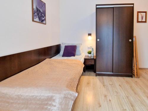 a bedroom with two beds and a closet at Villa Sarema in Chłopy