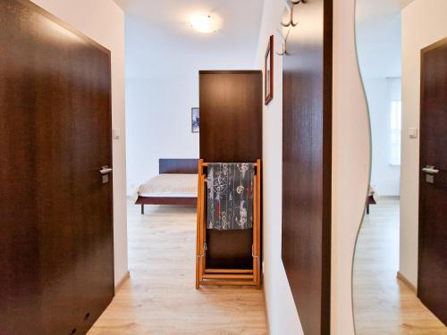 a hallway with a mirror and a door with a bed at Villa Sarema in Chłopy