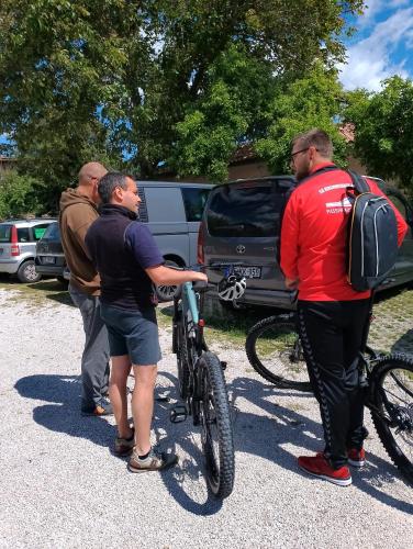 a group of men standing next to a bike at Hotel Aquila in Scoppito