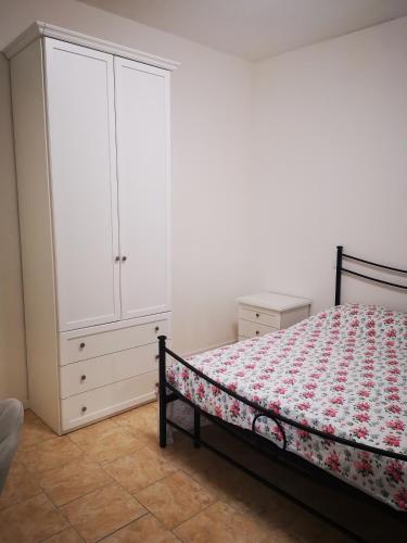 a bedroom with a bed and a white cabinet at Villa Liberty GHIRADA 1924 in Treviso