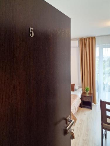 a door with the number on it in a bedroom at Villa Sarema in Chłopy