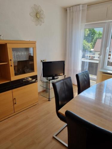 a living room with a dining room table and a television at Ferienwohnung Schamne in Wutöschingen