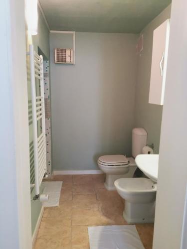 a bathroom with two toilets and a sink at Villa Liberty GHIRADA 1924 in Treviso