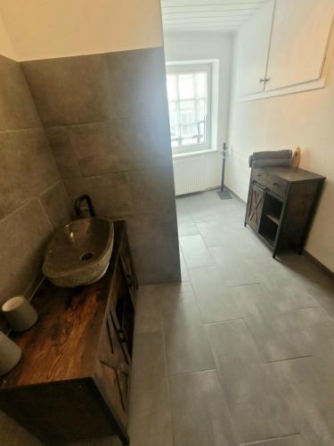 a bathroom with a sink and a counter in a room at Moderne Ferienwohnung in der Altstadt in Eschwege