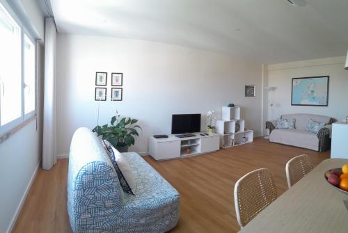 a living room with a couch and a table at Vistas Sobre O Rio Tejo in Lisbon