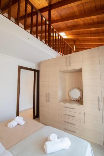 a bedroom with two white towels on a bed at Chris Luxury Loft in Kallithea Halkidikis