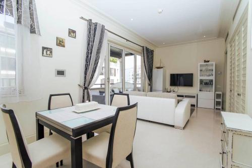a living room with a table and chairs and a couch at Porto Montenegro Milena 203 with Lovely Balcony in Tivat