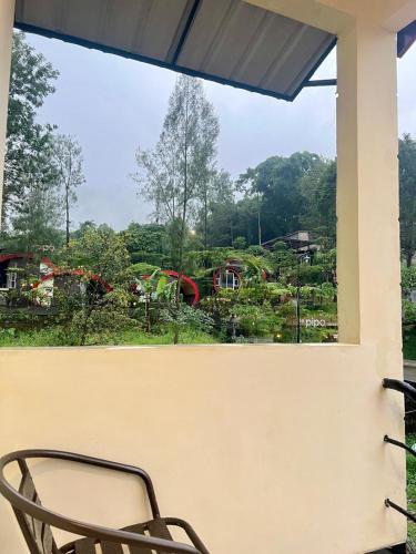a chair sitting on a porch looking out at a playground at de Pipo Bromo in Sukapura