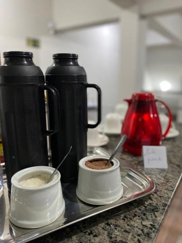 a counter with two cups of coffee on a tray at Hotel Gran Solar Br in Contagem