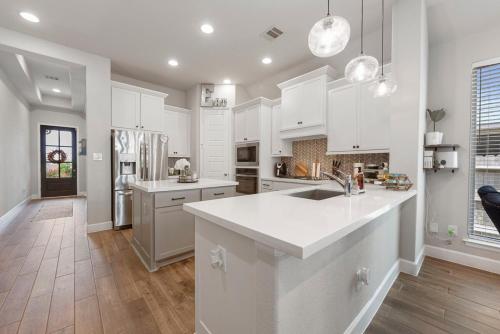 a kitchen with white cabinets and a white counter top at Lux Lake, Outdoor Kitchen, Near Fairgrounds in Magnolia