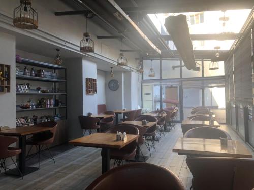 a restaurant with tables and chairs in a room at Class Hotel in Kırklareli