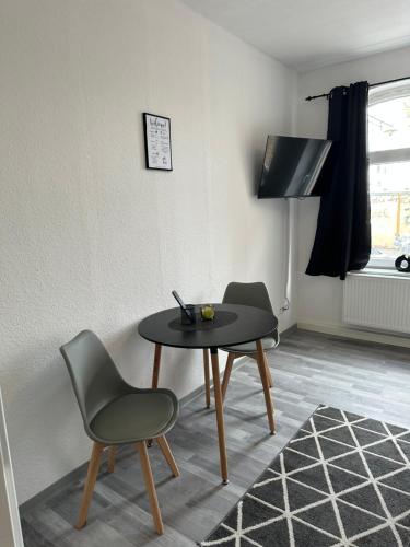 a room with a table and two chairs and a table at Apartment Gray Z2 in Erfurt