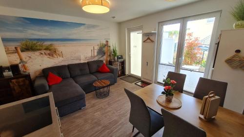 a living room with a couch and a table at Ferienwohnung Ostsee Graal-Müritz Küstenwald in Gelbensande