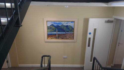 a hallway with a painting on a wall at Kintail Lodge Hotel in Kyle of Lochalsh