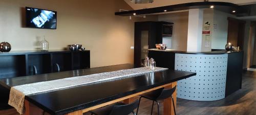 a bar with a black counter top in a room at Pico Blue Ocean - Sea House in São Roque do Pico