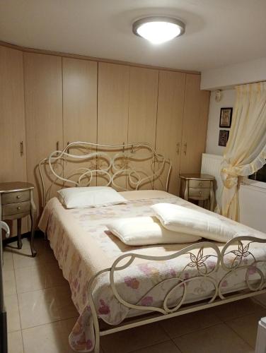 a bedroom with a bed and two night stands at Villa Kokalis Resort hotel in Gouves