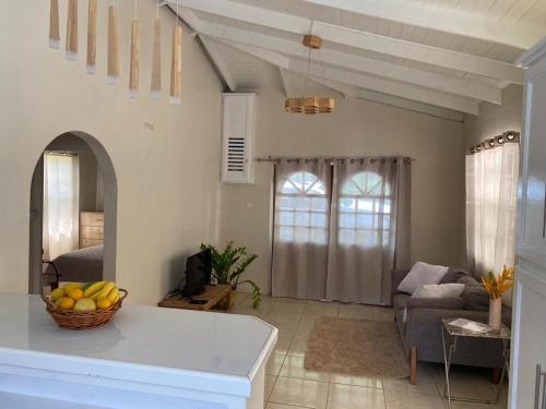 a living room with a bowl of fruit on a counter at 2 Bdr House in Laborie Village with full amenities in Vieux Fort