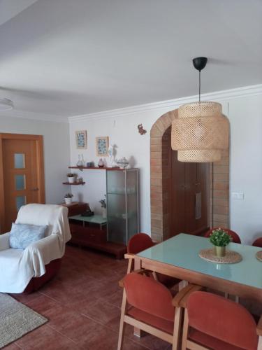 a living room with a table and a bed at Apartamento Salamandra 100m2 con terraza y piscina in Puzol