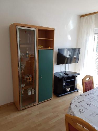 a bedroom with a green cabinet and a television at Ferienwohnung Schamne in Wutöschingen
