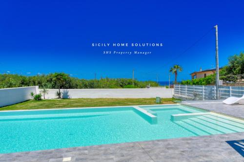 a swimming pool in the backyard of a house at Villa Stella con piscina privata 500 mt dal mare By Sicily Home Solutions in Trappeto