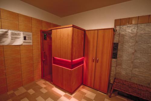 a bathroom with a wooden cabinet and a shower at Hotel Milord in Pułtusk