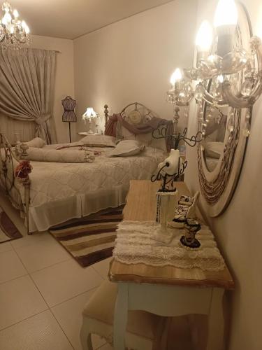 a bedroom with two beds and a table with a mirror at Villa Kokalis Resort hotel in Gouves