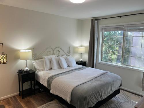 a bedroom with a bed with pillows and a window at Just Peachy 2BR 2BA Private Luxury Apartment in Atlanta