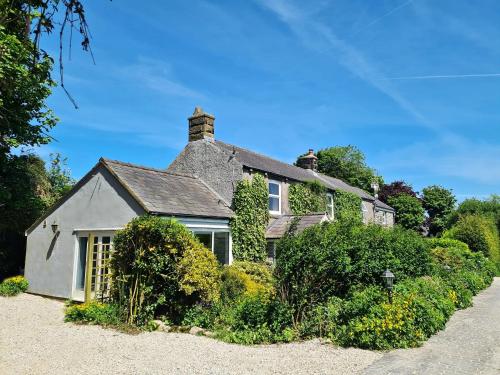 a house with ivy growing on the side of it at Bruntmoor Cottage in Bakewell