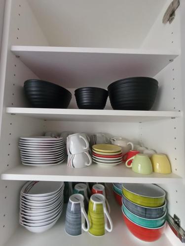 a cupboard filled with plates and bowls and dishes at 3,5 Zimmer Parterre Wohnung in Alpnach