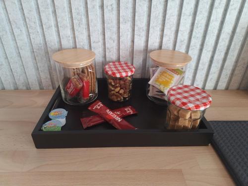 a black tray with containers of food on a table at Ambiance Bois & Charme Proche Lyon in Saint-Genis-les-Ollières