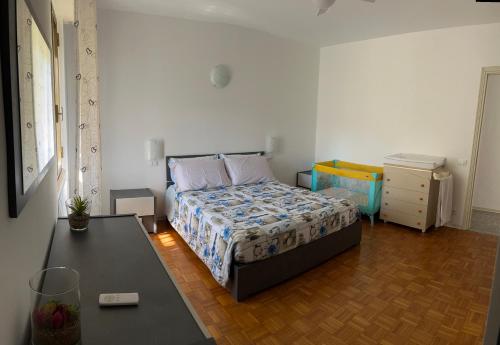 a bedroom with a bed and a table in it at Appartamento Trifoglio in Salò