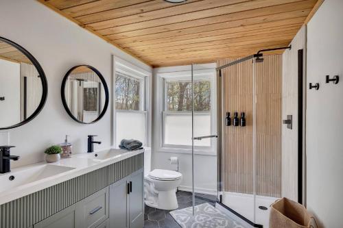 a bathroom with a toilet and a glass shower at Charming Retreat Walking in Tannersville