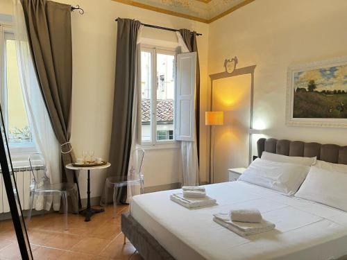 a bedroom with a large bed and a window at Fashion Florence Rooms in Florence