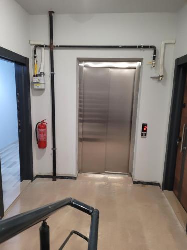 a metal door in a room with a fire hydrant at Mukka Apart Hotel - شقق موكا الفندقية in Trabzon