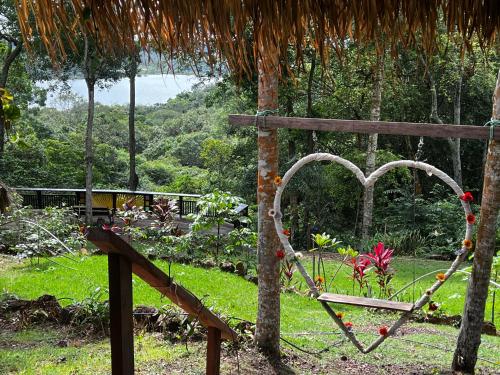 an open gate to a garden with a swing at TerrAmor Ecoliving in Alter do Chao