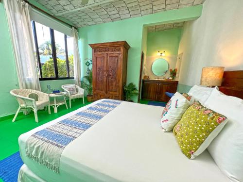 a bedroom with a large white bed and a window at Casa Nawalli Pickleball Resort & Retreats Adults Only in Sayulita