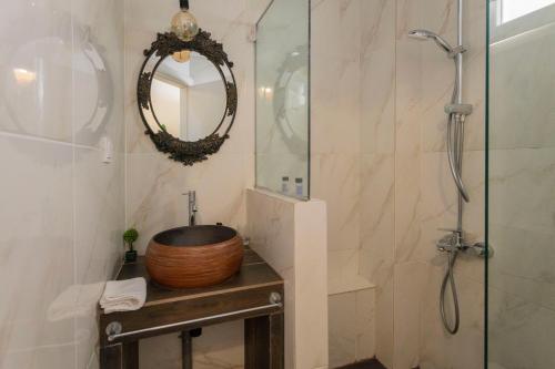 a bathroom with a shower and a sink and a mirror at Maisonette Pylos in Pylos
