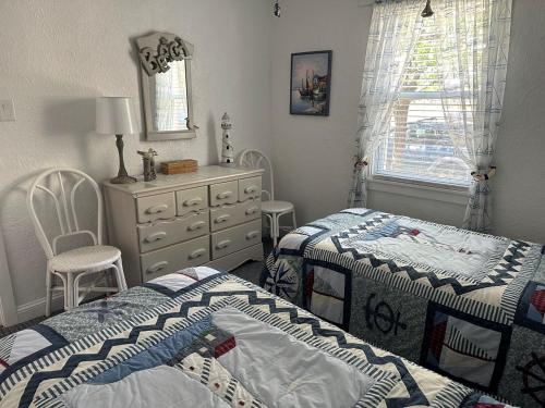 a bedroom with two beds and a dresser at Two-Bedroom Wildwood Crest Condo in Wildwood Crest